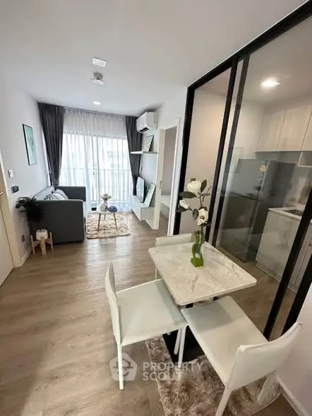 Modern open-plan living room and kitchen with stylish decor and natural light.