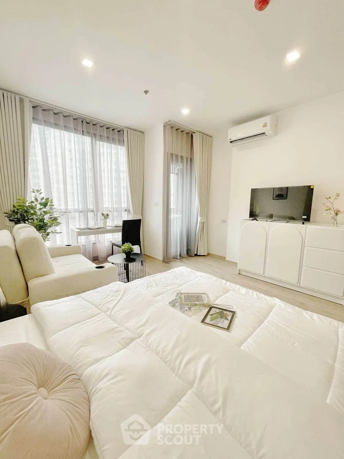 Bright and airy living room with modern decor and large windows in a stylish apartment.