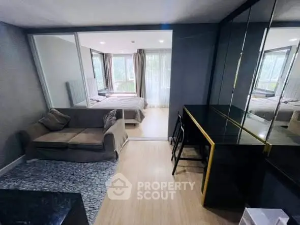 Modern studio apartment with cozy living area and stylish bedroom