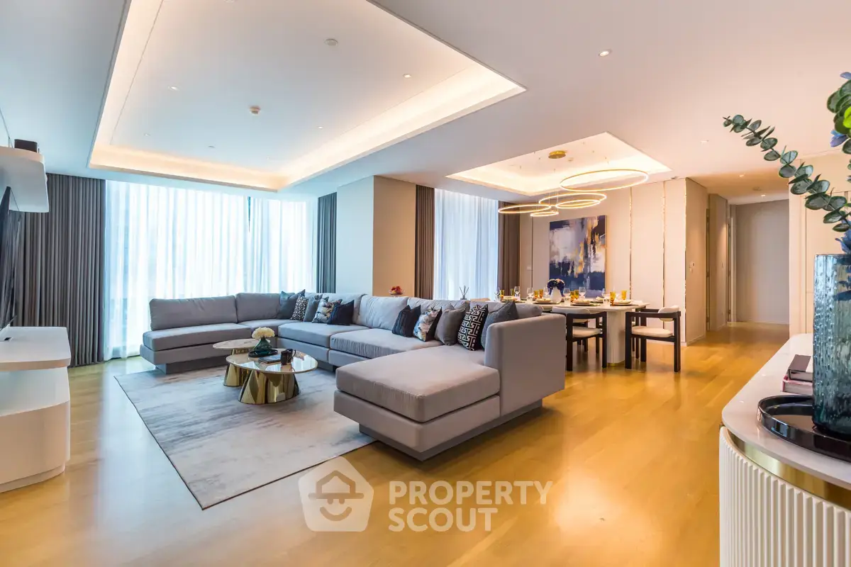 Luxurious modern living room with spacious seating and elegant dining area, featuring stylish decor and ample natural light.