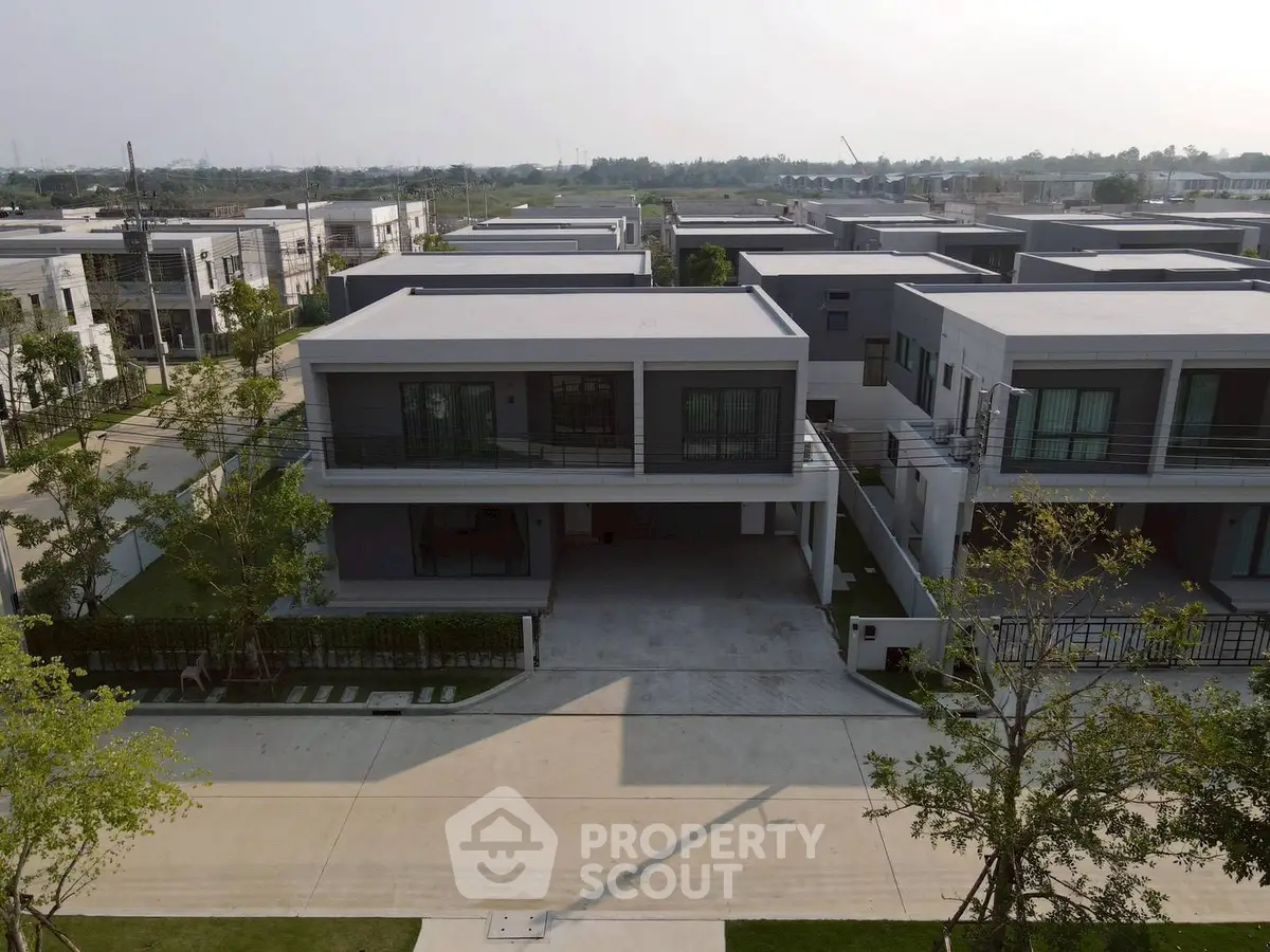 Modern residential complex with spacious driveways and lush greenery