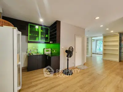 Spacious open-plan living area with modern kitchen and wooden flooring