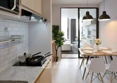 Modern open-plan kitchen and dining area with sleek design and natural light.