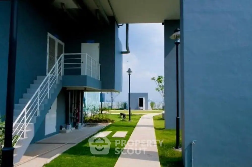Modern building exterior with landscaped garden and pathway