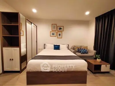 Modern bedroom with stylish decor and cozy seating area, perfect for relaxation.