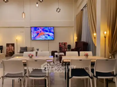 Spacious modern living room with elegant decor and ambient lighting, perfect for entertaining guests.