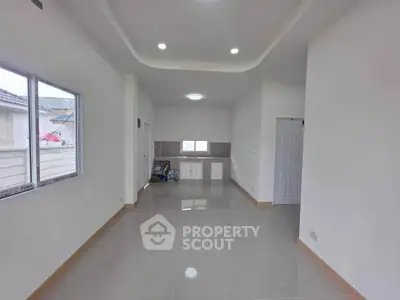 Spacious modern living room with sleek tile flooring and large windows for natural light.