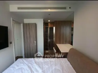 Modern bedroom with built-in closet and sleek wooden furniture