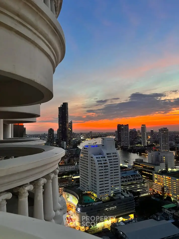Stunning cityscape view from a high-rise balcony at sunset, showcasing vibrant skyline and river.