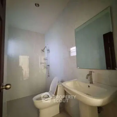 Modern bathroom with sleek fixtures and elegant marble walls.