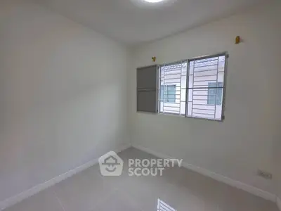 Bright empty room with tiled floor and window view in modern home