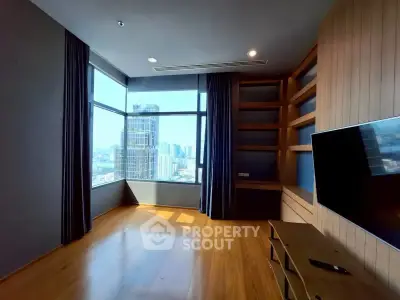 Spacious modern living room with city view and built-in shelves