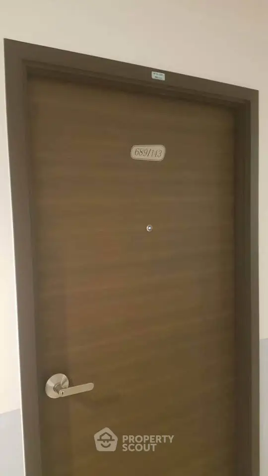 Modern apartment door with sleek handle and peephole, showcasing secure and stylish entryway.