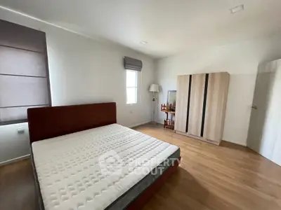 Spacious bedroom with modern furnishings and natural light