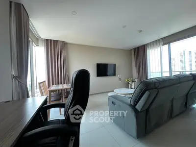Spacious living room with modern furniture and city view, perfect for relaxation and entertainment.