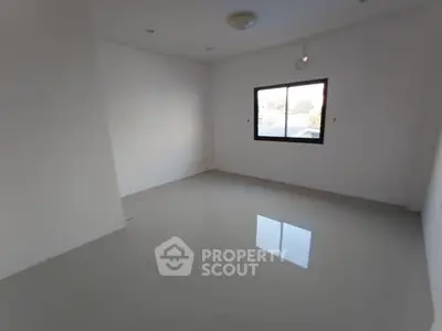 Spacious empty room with large window and glossy tiled floor, perfect for customization.