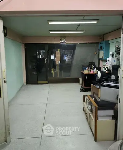 Spacious empty room with potential for customization, featuring large glass doors and ample storage space.