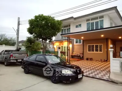Charming two-story house with spacious driveway and modern exterior design, perfect for family living.