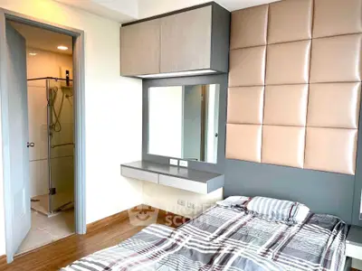 Modern bedroom with stylish decor and ensuite bathroom in a contemporary apartment.