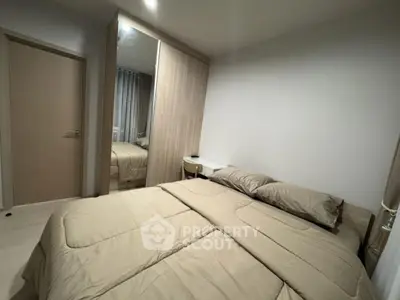 Cozy bedroom with modern decor and mirrored wardrobe