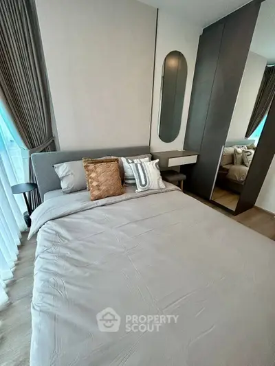 Modern bedroom with stylish decor and large mirror wardrobe