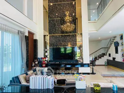 Luxurious living room with high ceilings, elegant decor, and modern furnishings in a spacious open layout.