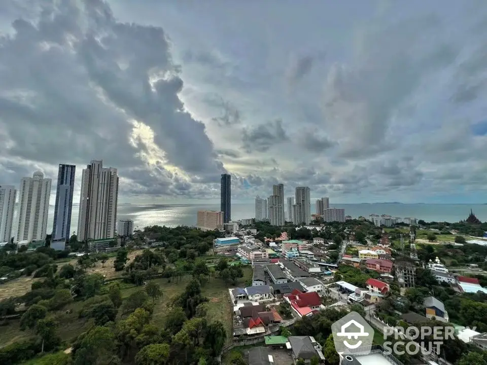 Stunning panoramic cityscape view with high-rise buildings and lush greenery under dramatic skies.