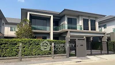 Modern two-story house with sleek design and spacious balcony in a serene neighborhood.