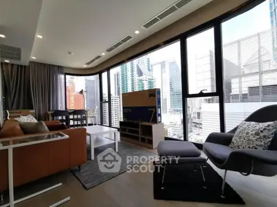 Modern living room with floor-to-ceiling windows and city view