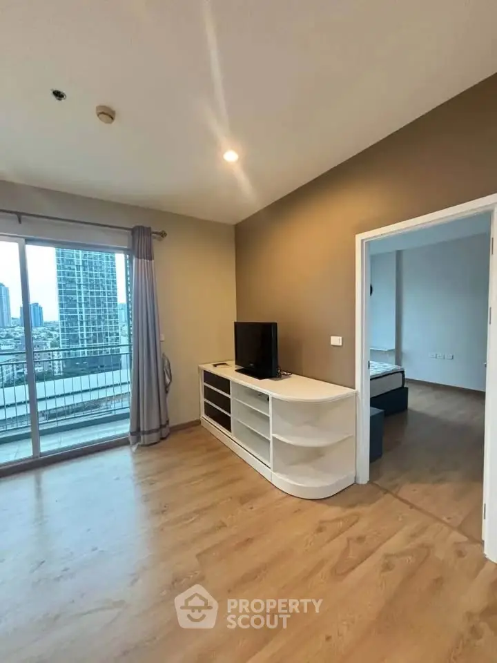 Spacious living room with balcony and city view in modern apartment