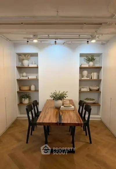 Stylish dining area with wooden table and modern decor, perfect for contemporary living.
