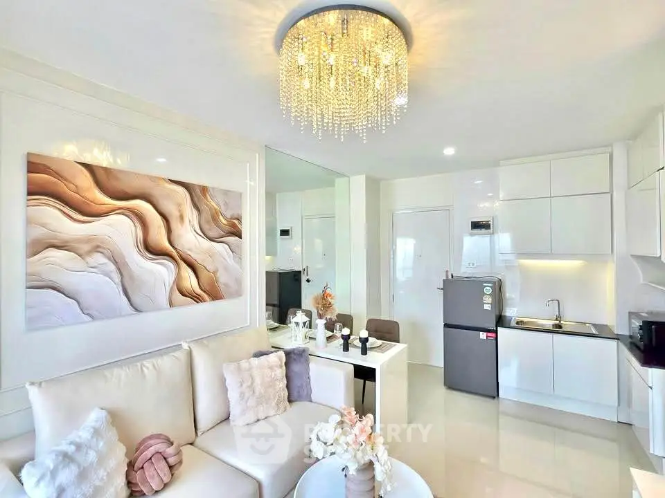 Luxurious modern living room with elegant chandelier and sleek kitchen design