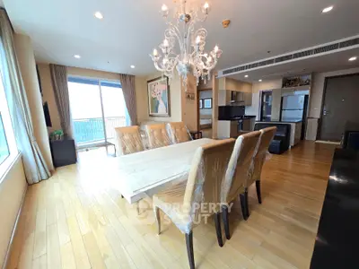 Spacious modern living room with elegant chandelier and open kitchen layout