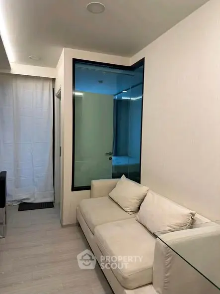 Modern living room with sleek design and cozy white sofa, perfect for relaxation.