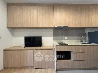 Modern kitchen with sleek wooden cabinetry and built-in appliances