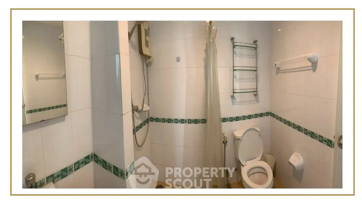 Spacious bathroom with shower and modern fixtures in a stylish apartment.