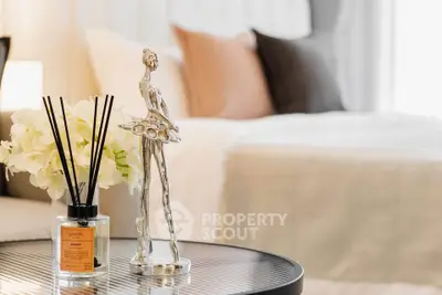 Elegant bedroom decor with stylish sculpture and cozy bedding