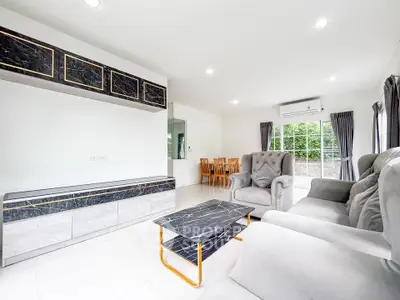 Spacious modern living room with elegant marble accents and plush seating