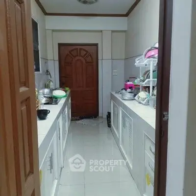Spacious kitchen with closed layout and modern appliances, featuring ample counter space and storage.