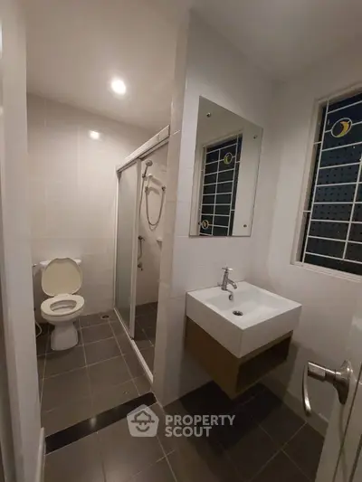 Modern bathroom with sleek fixtures and glass shower enclosure