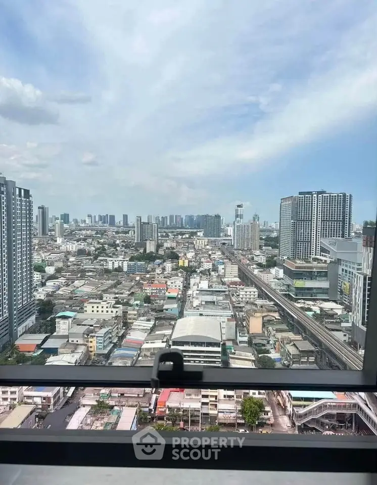 Stunning cityscape view from high-rise building window showcasing urban skyline.