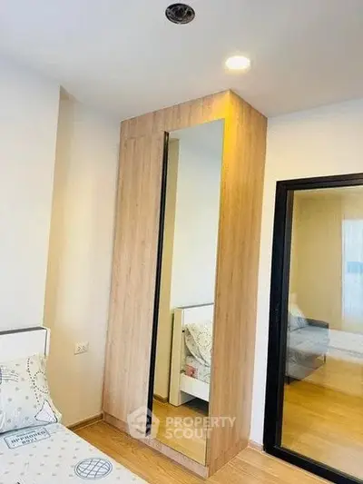 Modern bedroom with mirrored wardrobe and cozy decor