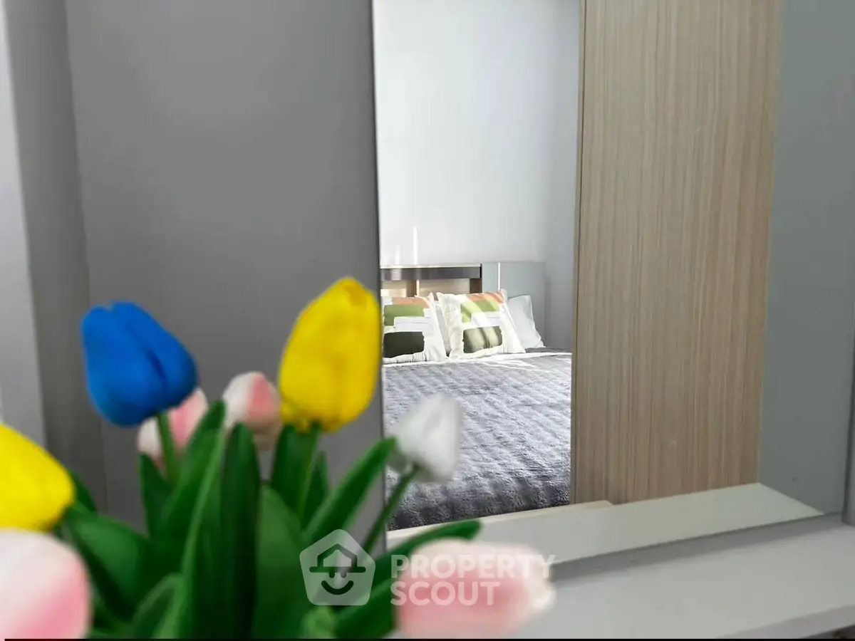 Stylish bedroom with modern decor and colorful flower arrangement