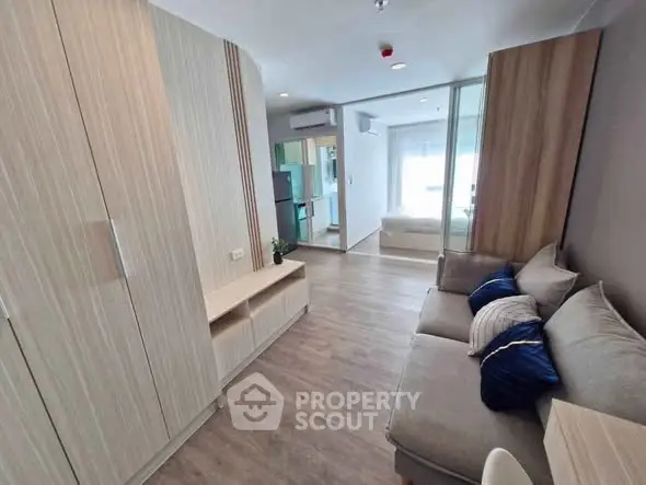 Modern living room with cozy sofa and stylish decor in a contemporary apartment.