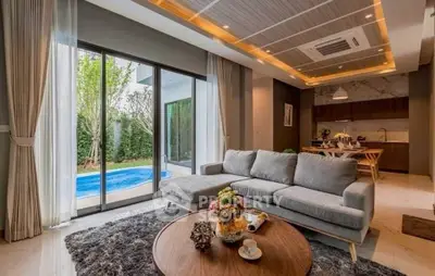 Luxurious living room with pool view, modern decor, and open layout for ultimate comfort and style.