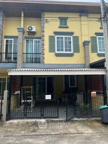 Charming townhouse exterior with gated entrance and balcony, perfect for modern living.