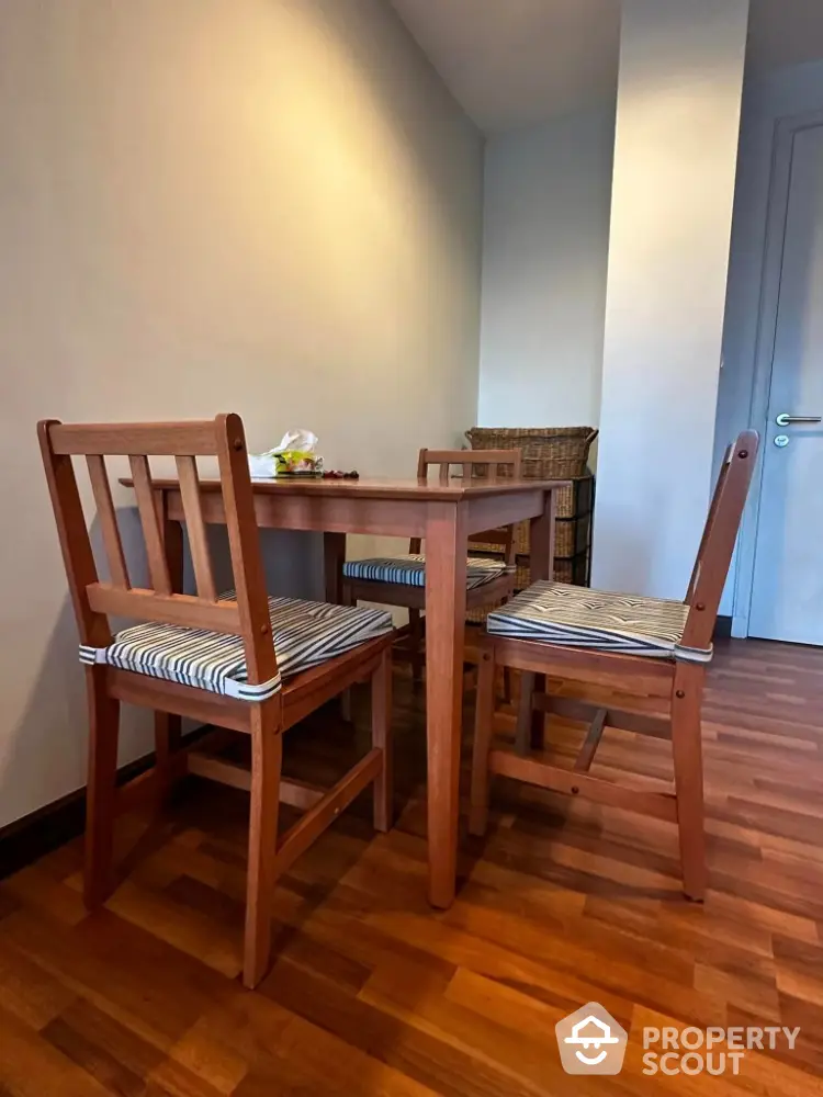 Cozy dining area with wooden table and chairs in a modern apartment