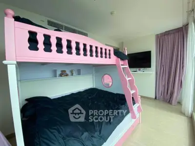 Charming bedroom with pink bunk bed and modern decor, perfect for kids.