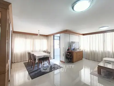 Spacious living room with elegant dining area and natural light