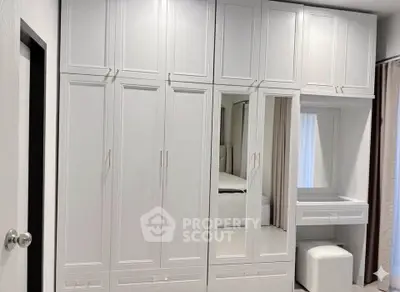 Spacious white wardrobe with mirror in modern bedroom